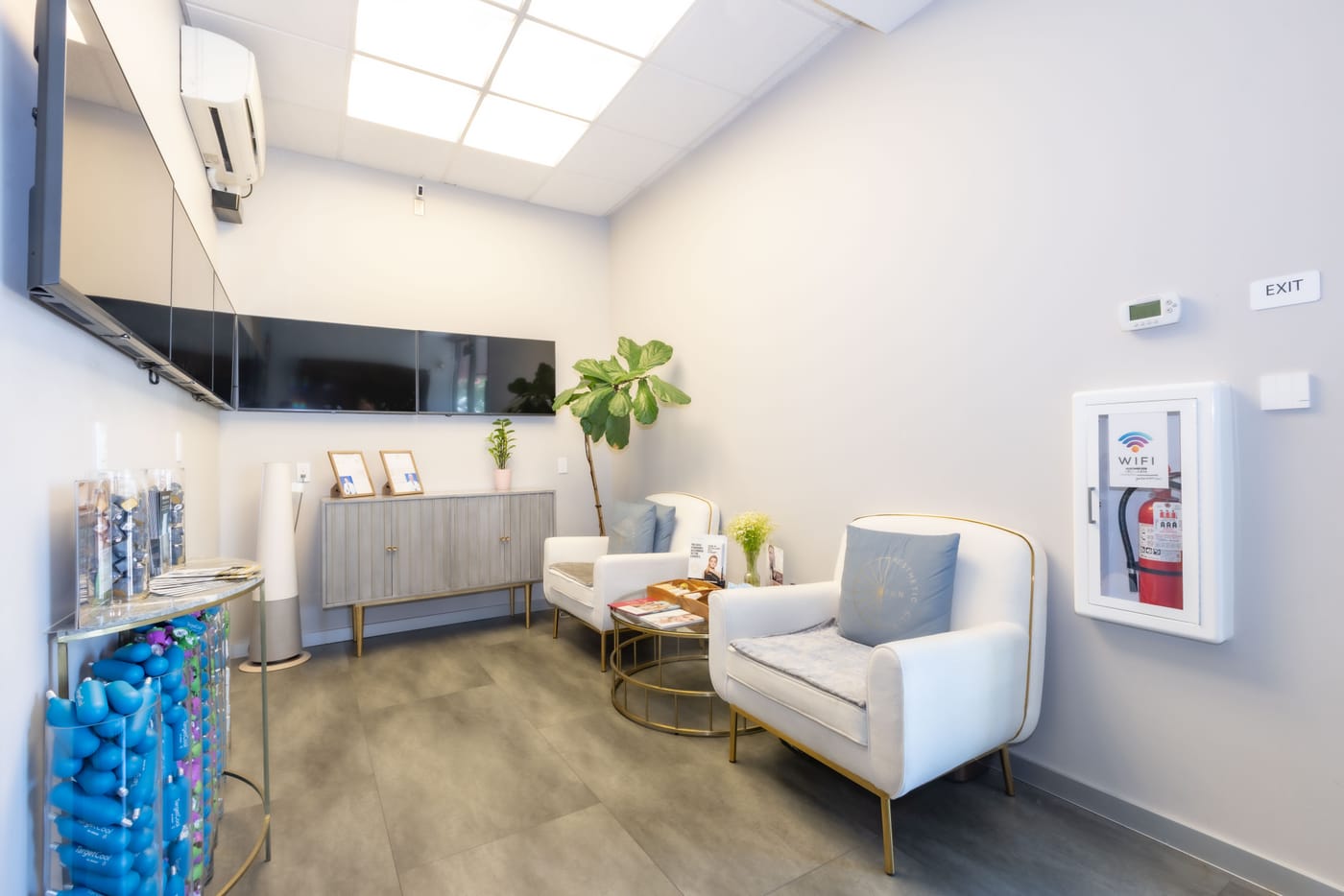 The lobby at Sun Aesthetic Clinic — armchairs, soft lighting, branded pillows