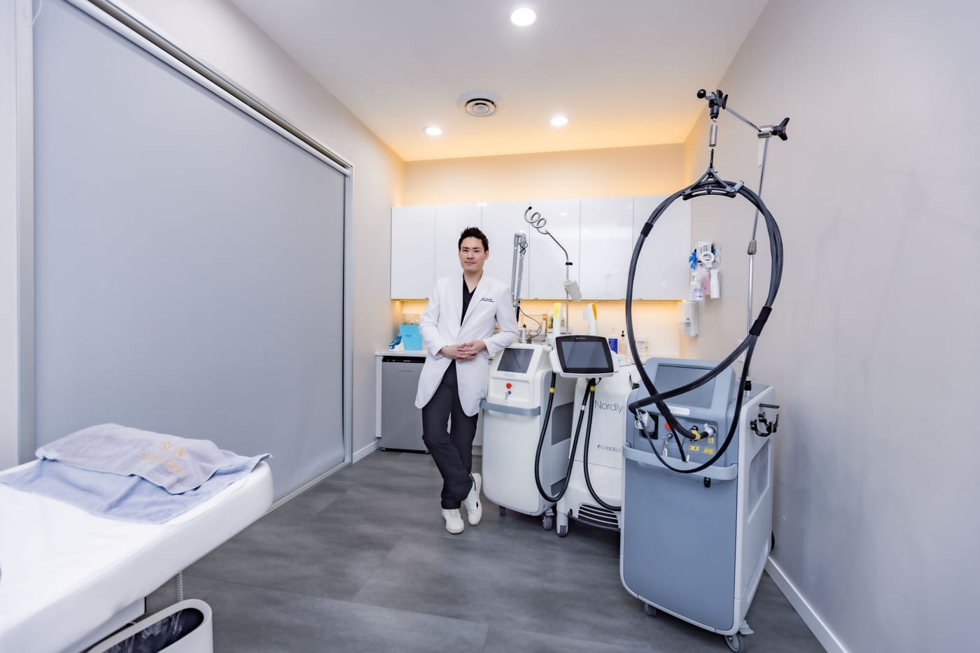 Dr. Albert Yang with the clinic's Candela laser platforms