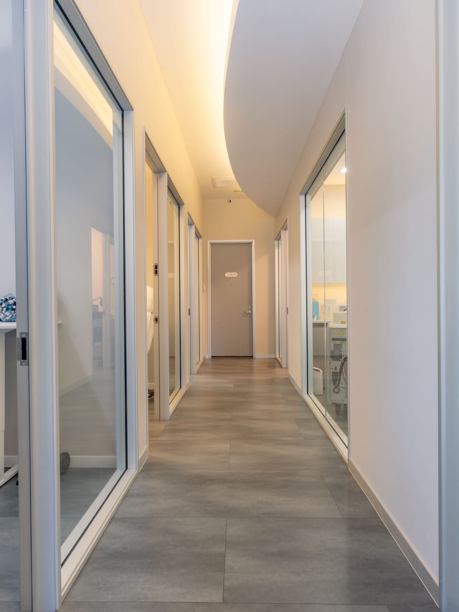 Glass-walled treatment room corridor