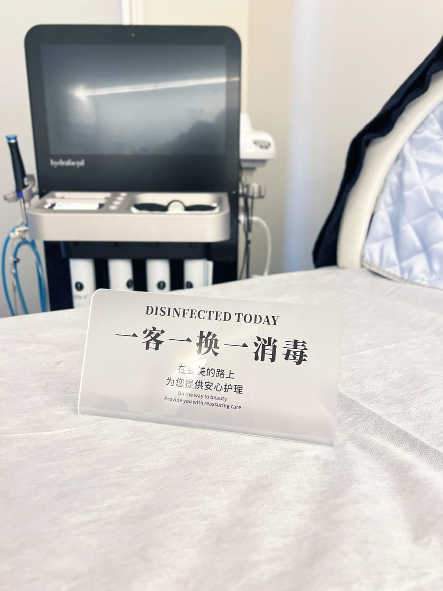 Treatment bed with disinfected-today card — sanitized between every patient