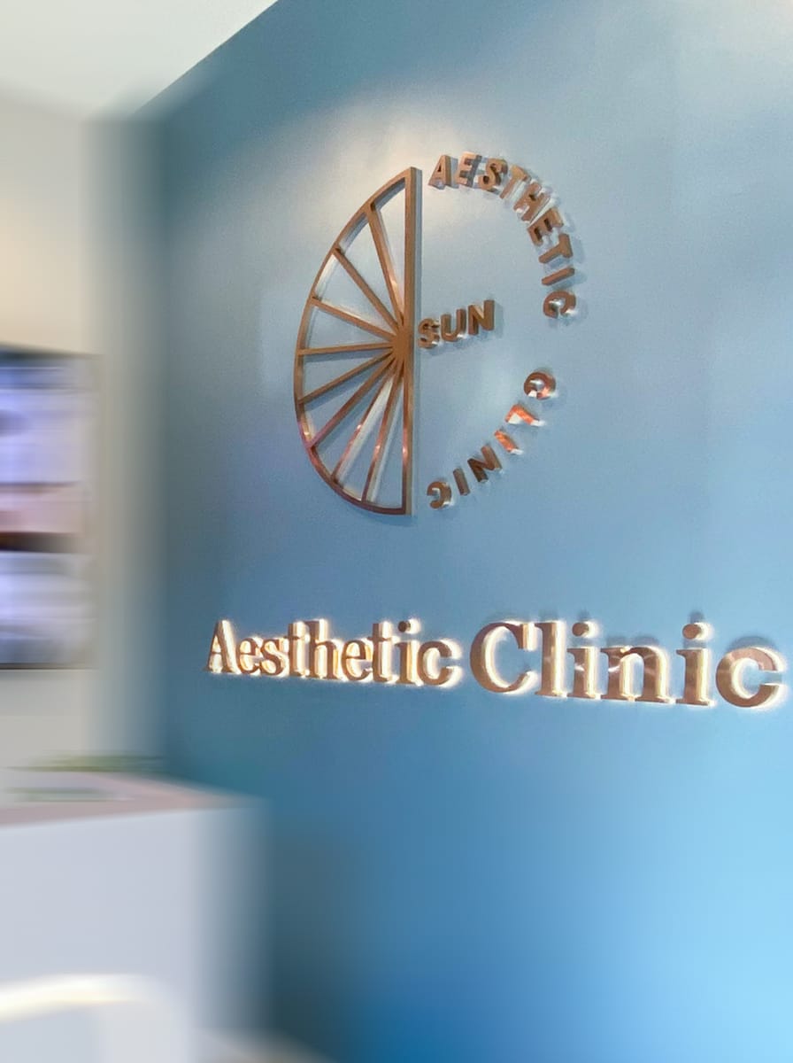 Sun Aesthetic Clinic reception logo wall